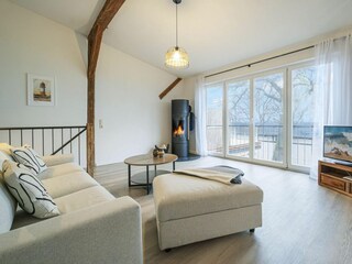 Wohnbereich mit Meerblick, Couch, Ofen und Küche