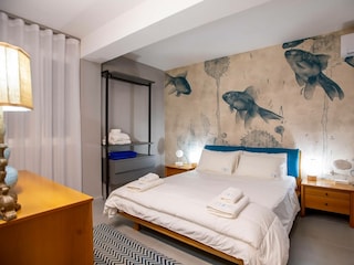 Bedroom with air conditioner and double bed