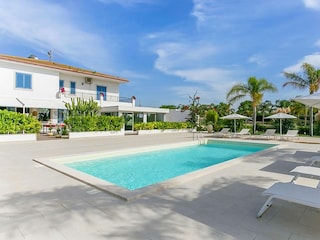 Large pool area with sun loungers
