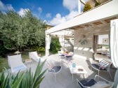 The patio with a view of the studio and the garden