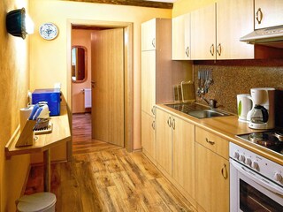 Kitchen with view into the bedroom