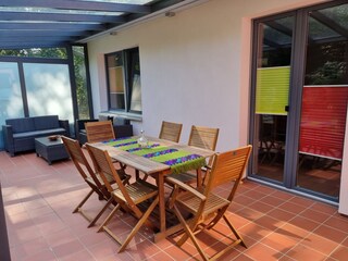 Terrace with glass roof and sheltered from the wind