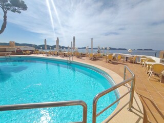 Communal pool with adjacent restaurant