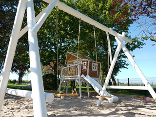 Giant sandpit with a stilt house