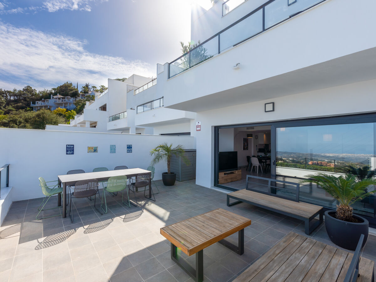 The largest of the 3 terraces with lounge and dining table