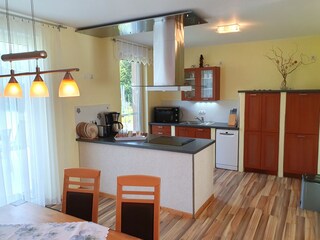 Living room with open kitchen and dining table