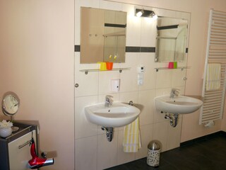 Modern bathroom with hairdryer and soap dispenser
