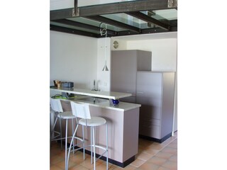 Kitchen and dining bar under glass floor gallery