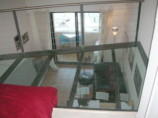 View from glass floor gallery into living room