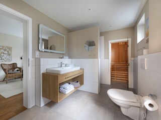 Badezimmer mit ebenerdiger Dusche und Sauna