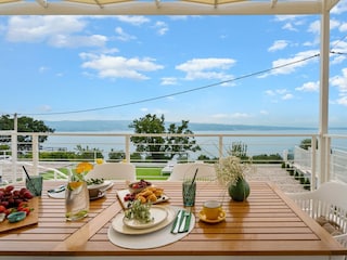 In front of the living room is a covered outdoor dining