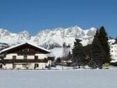 Haus Zierl im Hintergrund der Wilde Kaiser