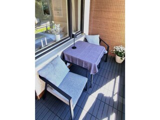 Sunny balcony, armchairs, bench & dining table
