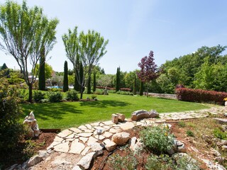 Large fenced garden with many plants and flowers