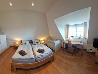 Upstairs bedroom with baby cot