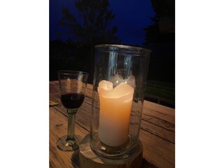 A glass wine with candle light on the terrace