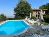 Pool with view to the house and valley