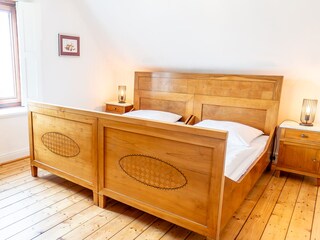Large bedroom with an antique cherrywood double bed