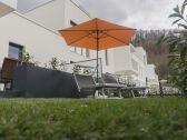 Garden with sun loungers and parasol