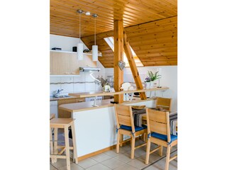 Dining nook with bar and kitchen