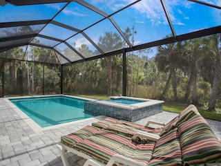 Swimming pool with hot tub and loungers