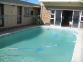 Swimming Pool and Bar  inside open doors