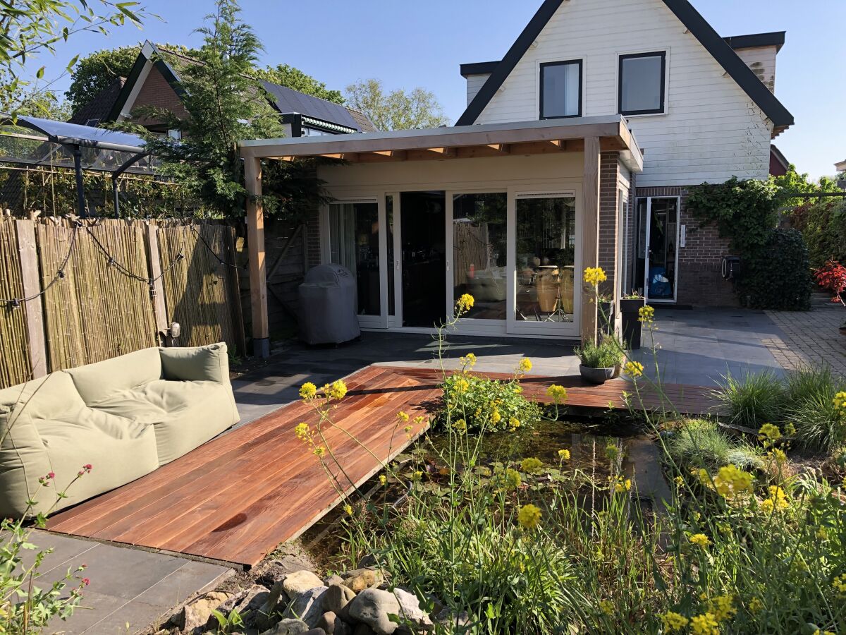 Back yard with pond and veranda