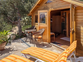 Terrasse vor der dem Blockhaus mit Sauna und Sportgerät