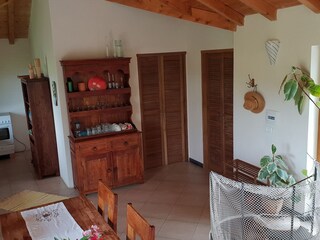 Wohnzimmer mit Zugängen zu Bad und Schlafzimmer rechts