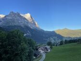 Unser Haus inmitten grüner Alpwiesen, mit dem Eiger