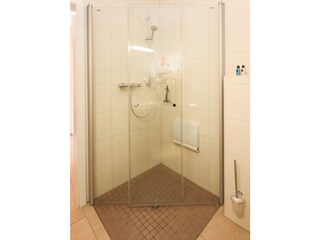 bodentiefe Dusche mit festinstalliertem Sitz