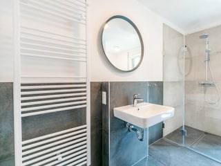 Badezimmer mit Waschbecken und Dusche