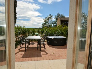 Private courtyard with hot tub and dining table