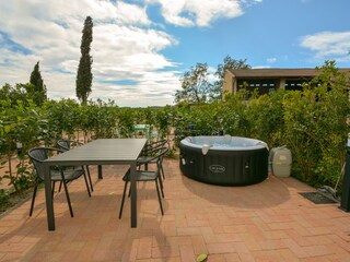 Private courtyard with hot tub and dining table