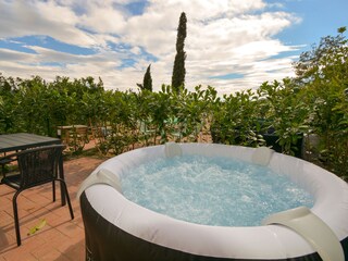 Private courtyard with hot tub and dining table