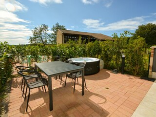 Private courtyard with hot tub and dining table