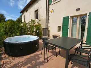 Private courtyard with hot tub and dining table