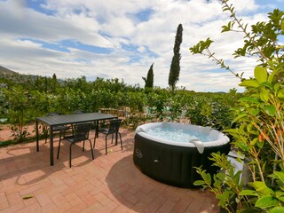 Private courtyard with hot tub and dining table