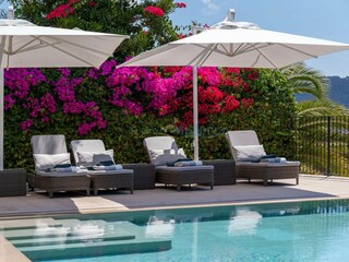 Poolside with quality loungers and parasols