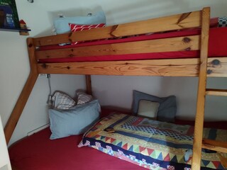 the children's room upstairs with 3 sleeping spaces