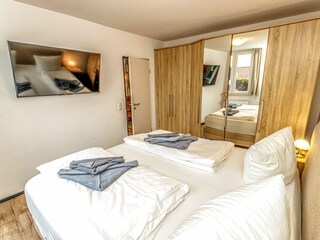 Modernes Schlafzimmer mit großem, gemütlichen Doppelbett