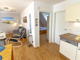 Gemütliches und helles Wohnzimmer mit integriertem Essbereich und schicker Küchenzeile