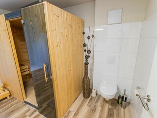 Modernes Badezimmer mit großer Dusche, Sauna und Waschmaschine