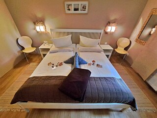 Schlafzimmer mit Doppelbett und Kleiderschrank