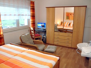 Bedroom with wash basin HD TV and PC