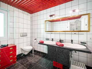 Bathroom with double sink and toilet