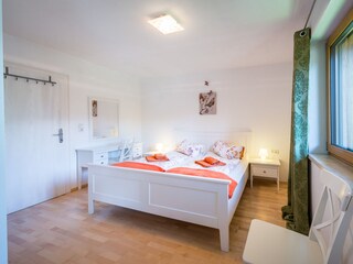 Bedroom with double bed and table