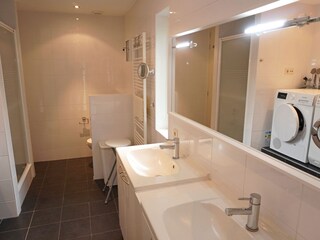 Badezimmer mit Dusche, Toilette und 2 Waschbecken