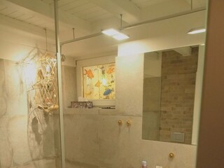 Badezimmer mit ebenerdiger, begehbarer Dusche und Fenster