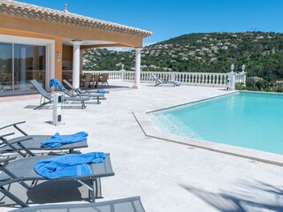 Terrace with numerous sun beds and pool